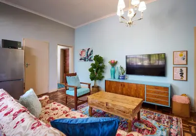 a living room with a couch and a table at The BeeKeeper's Inn in Louis Trichardt