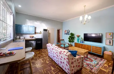 a living room with a kitchen and a dining room at The BeeKeeper's Inn in Louis Trichardt