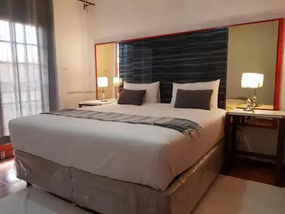 a large bed with a large headboard in a bedroom at Aloe 40 in Burgersfort
