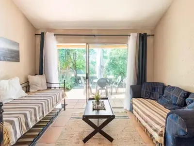 a living room with two couches and a table at 1 Bedroom Cottage in Midrand