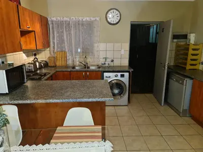 a kitchen with a sink and a counter top at Midrand Ninth on Lever Shalom in Midrand