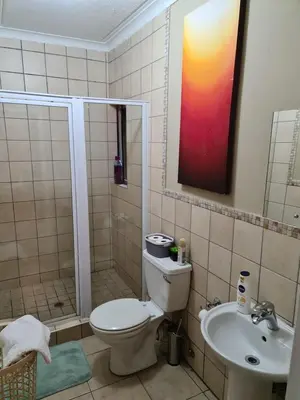 a bathroom with a toilet and a sink at Midrand Ninth on Lever Shalom in Midrand