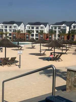 a group of chairs and umbrellas on a beach at The Blyde in Pretoria