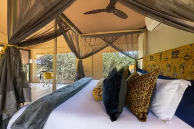 a bedroom with a bed with a canopy at Oase by 7 Star Lodges - Greater Kruger Private 530ha Reserve in Hoedspruit