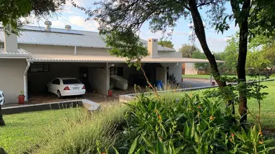 a house with a car parked in front of it at Stay Harties Accommodation in Hartbeespoort