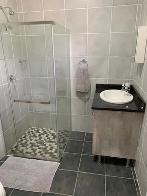 a bathroom with a shower and a sink at Stay Harties Accommodation in Hartbeespoort