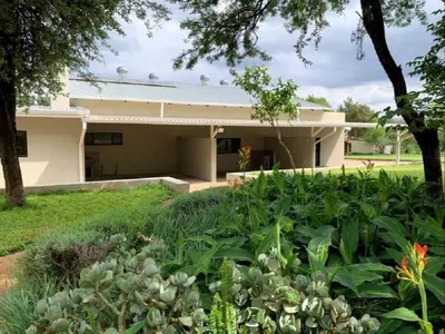 a house with a garden in front of it at Stay Harties Accommodation in Hartbeespoort
