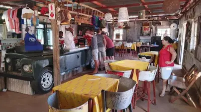 a group of people in a restaurant with tables and chairs at Milkwood Valley Lodge, Mabalingwe in Bela-Bela