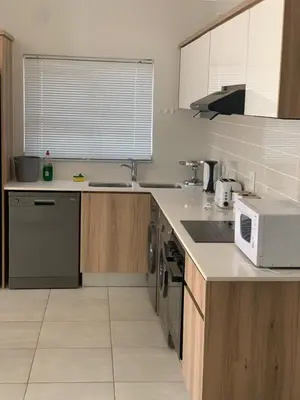 a kitchen with a sink and a microwave at THE BLYDE CRISTAL LAGOON in Pretoria