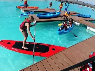 a woman on a red paddle board in the water at THE BLYDE CRISTAL LAGOON in Pretoria