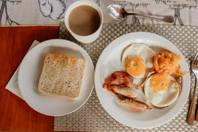 a plate of eggs and toast and a cup of coffee at Franks Bush Camp in Hoedspruit
