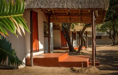 a building with a thatched roof and a porch at Franks Bush Camp in Hoedspruit