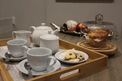 a tray with cups and plates of food on a table at Furnished, 1-bedroom, luxury apartment in Menlyn Maine in Pretoria