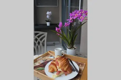a plate of croissants and croissants on a table at Furnished, 1-bedroom, luxury apartment in Menlyn Maine in Pretoria