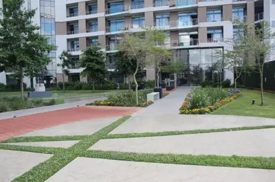 a walkway in front of a building at Furnished, 1-bedroom, luxury apartment in Menlyn Maine in Pretoria