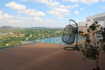 a view of a balcony with a tennis racket at Furnished, 1-bedroom, luxury apartment in Menlyn Maine in Pretoria