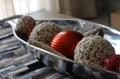 a bowl filled with different colored balls on a table at Furnished, 1-bedroom, luxury apartment in Menlyn Maine in Pretoria