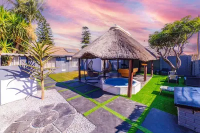 a backyard with a gazebo with a grass roof at Homes of Ace Executive in Pretoria