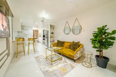 a living room with a yellow couch and a table at Homes of Ace Executive in Pretoria