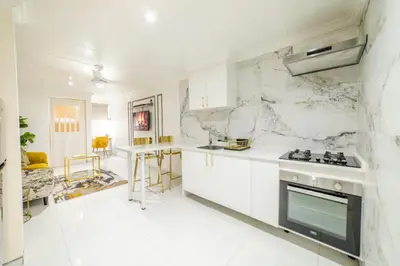 a kitchen with white marble walls and a stove at Homes of Ace Executive in Pretoria