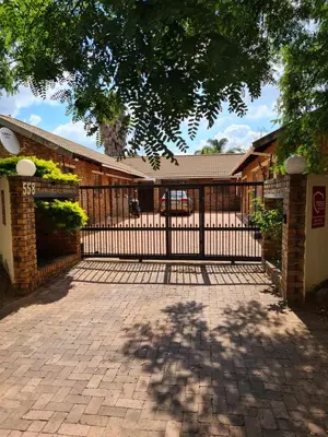 a black gate in front of a house at Baraka House in Midrand