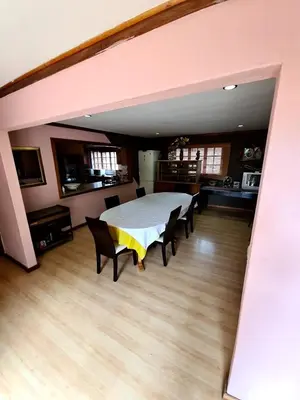 a bedroom with a bed and chairs in a room at Baraka House in Midrand