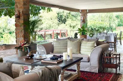 a living room with a couch and a table at Tomjachu Bush Retreat in Nelspruit