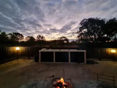 a fire pit in a backyard with at Pumba's Place Zebula 6 Bedroom House in Mabula