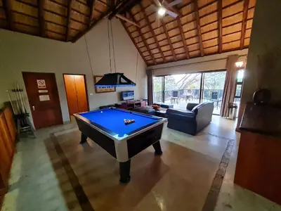 a living room with a pool table in it at Pumba's Place Zebula 6 Bedroom House in Mabula