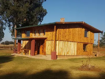 a large wooden building with the door open at Rainbow Lodge in Belfast