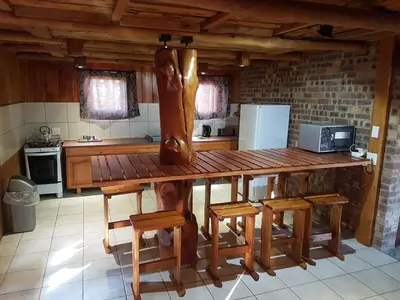 a kitchen with a large wooden table and chairs at Rainbow Lodge in Belfast