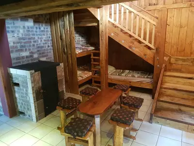 an attic room with a table and chairs and stairs at Rainbow Lodge in Belfast