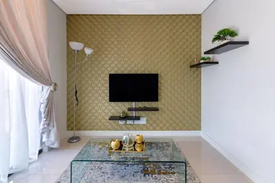 a living room with a tv on a wall at Alimama Spaces: The Chelsea's Ellipse in Midrand