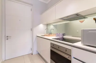 a white kitchen with a sink and a microwave at Alimama Spaces: The Chelsea's Ellipse in Midrand