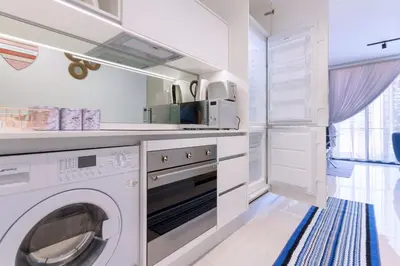 a white laundry room with a washer and dryer at Alimama Spaces: The Chelsea's Ellipse in Midrand