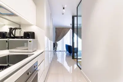 a kitchen with white appliances and a glass wall at Alimama Spaces: The Fountain Hill Ellipse in Midrand