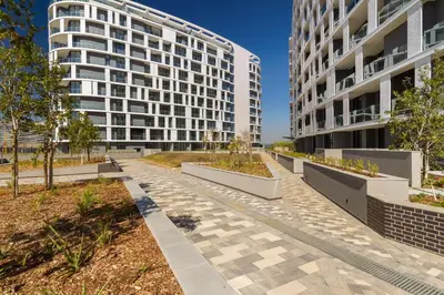 an empty street in front of two tall buildings at Alimama Spaces: The Fountain Hill Ellipse in Midrand