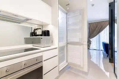 a kitchen with white cabinets and a microwave at Alimama Spaces: The Fountain Hill Ellipse in Midrand