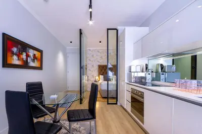 a kitchen and dining room with a table and chairs at Alimama Spaces: The Manson's Ellipse in Midrand