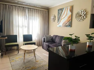 a living room with a couch and a table at Tshamani self catering in Hazyview