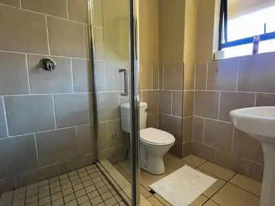 a bathroom with a toilet and a sink at Tshamani self catering in Hazyview