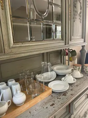 a counter with plates and cups and glasses on it at Cozy Coleman in Hartbeespoort