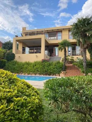 a house with a swimming pool in front of it at Cozy Coleman in Hartbeespoort