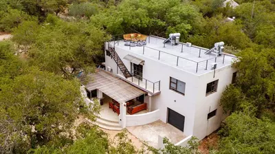 an overhead view of a white house in the woods at Jackals Dream - Self Catering Villa bordering Kruger National Park in Marloth Park
