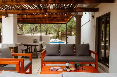 a patio with a couch and a table at Jackals Dream - Self Catering Villa bordering Kruger National Park in Marloth Park