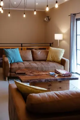 a living room with a couch and a coffee table at Jackals Dream - Self Catering Villa bordering Kruger National Park in Marloth Park