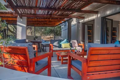 an outdoor patio with chairs and a table at Jackals Dream - Self Catering Villa bordering Kruger National Park in Marloth Park