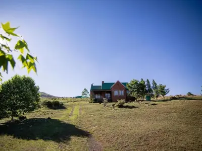 a house in the middle of a field at Glen Aden in Dullstroom