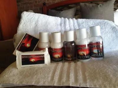 a group of four bottles of hair products on a bed at Sundowners Game Lodge in Marble Hall