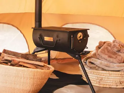a grill on a stand next to a basket of bread at The Leadwood Safari Camp in Dinokeng Game Reserve